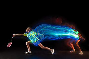 Image showing one caucasian young teenager girl woman playing Badminton player on black background