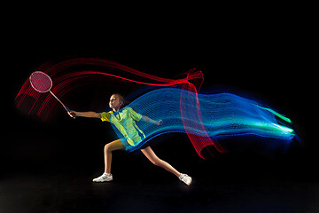 Image showing one caucasian young teenager girl woman playing Badminton player on black background