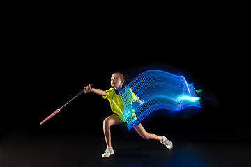 Image showing one caucasian young teenager girl woman playing Badminton player on black background