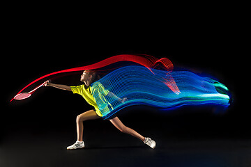 Image showing one caucasian young teenager girl woman playing Badminton player on black background