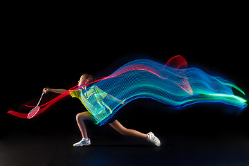 Image showing one caucasian young teenager girl woman playing Badminton player on black background