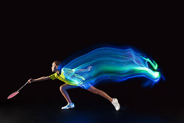 Image showing one caucasian young teenager girl woman playing Badminton player on black background