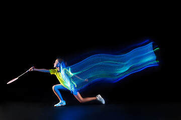 Image showing one caucasian young teenager girl woman playing Badminton player on black background