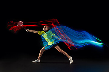 Image showing one caucasian young teenager girl woman playing Badminton player on black background