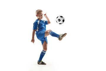 Image showing Young boy with soccer ball doing flying kick