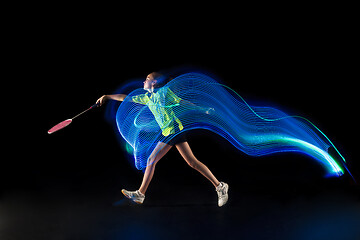 Image showing one caucasian young teenager girl woman playing Badminton player on black background