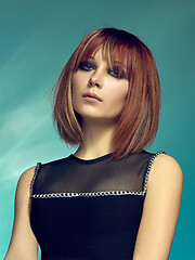 Image showing Close-up indoor portrait of lovely girl with colorful hair. Studio shot of graceful young woman with short haircut