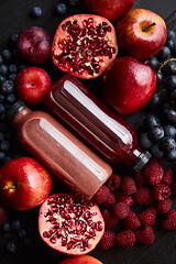 Image showing Mix of fresh red and black fruits. With botteled fresh juices