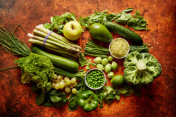 Image showing Fresh green vegetables and fruits assortment placed on a rusty metal