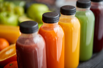 Image showing Colorful bottles filled with fresh fruit and vegetable juice or smoothie