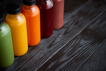 Image showing Colorful bottles filled with fresh fruit and vegetable juice or smoothie