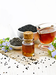 Image showing Oil kalingi in bottle and gravy boat on light wooden board