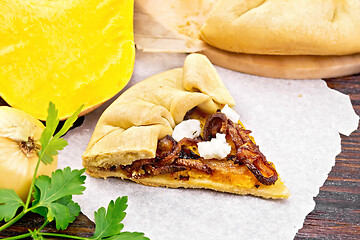 Image showing Pie with pumpkin and fried onions on wooden board