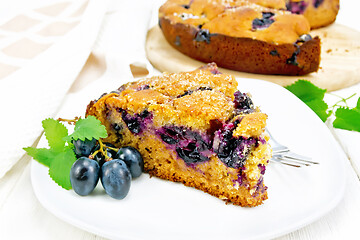 Image showing Pie with black grapes  in plate on board