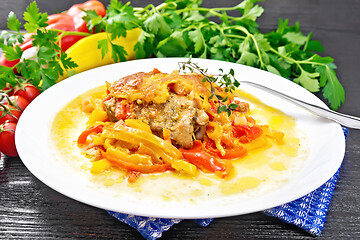 Image showing Chicken with pepper in white plate on dark board