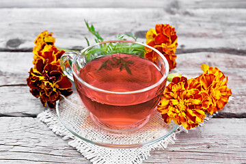Image showing Tea herbal of marigolds in cup on board