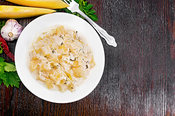 Image showing Pumpkin with sour cream sauce in plate on wooden board top