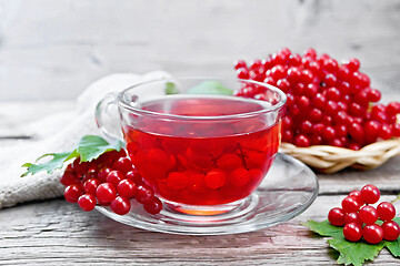 Image showing Tea from viburnum in cup with berries on board