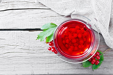 Image showing Tea from viburnum in cup with berries on board top