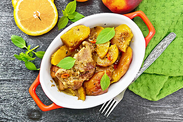 Image showing Turkey with peaches in pan on black board top