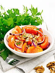 Image showing Salad with tomato and walnut in plate on white board