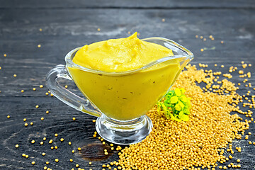 Image showing Sauce mustard in sauceboat with flower on black board