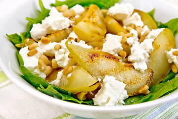 Image showing Salad from pear and spinach in dish on napkin