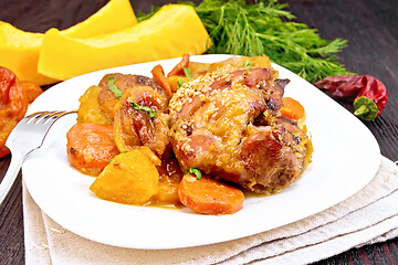 Image showing Chicken roast with pumpkin and carrots on dark board