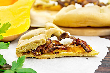 Image showing Pie with pumpkin and fried onions on dark board