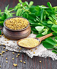 Image showing Fenugreek in spoon and bowl with green leaves on burlap