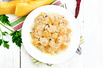 Image showing Pumpkin with sour cream sauce in plate on board top