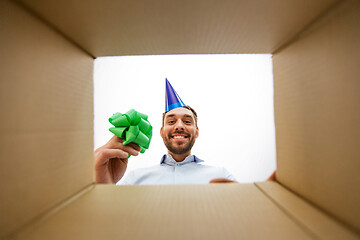 Image showing happy man opening parcel box or birthday gift