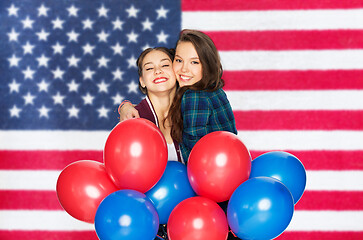 Image showing teenage girls with balloons over american flag