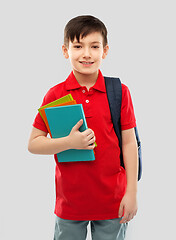 Image showing smiling schoolboy with books and school bag