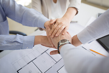 Image showing close up of business team stacking hands