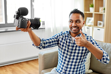Image showing male video blogger with camera blogging at home