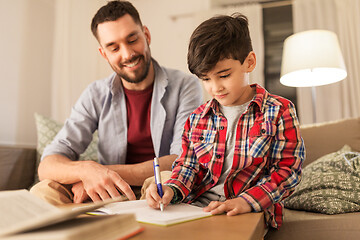 Image showing father and son doing homework together