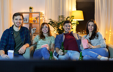 Image showing friends with beer and popcorn watching tv at home