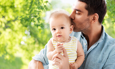 Image showing father kissing little baby daughter