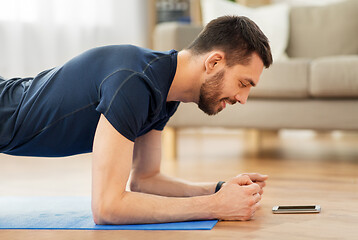 Image showing man doing plank exercise at home