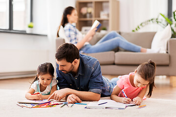 Image showing father with little daughters drawing at home