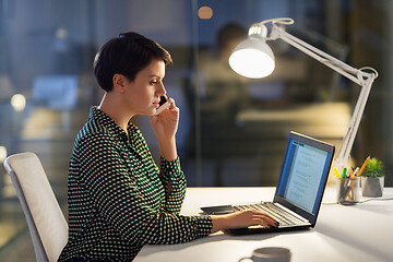 Image showing businesswoman calling on smartphone at office