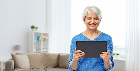 Image showing senior woman using tablet computer at home