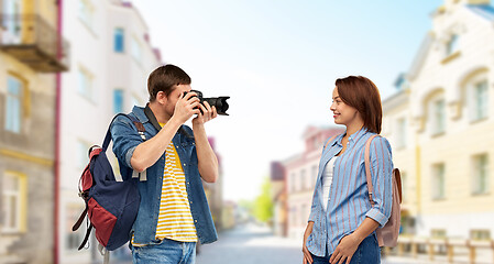 Image showing happy couple of tourists with backpacks and camera