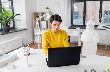 Image showing businesswoman with laptop working at office