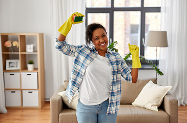 Image showing happy african woman with sponge cleaning at home