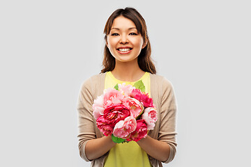 Image showing happy asian woman with bunch of flowers