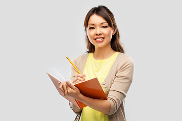 Image showing asian student woman with books and pencil