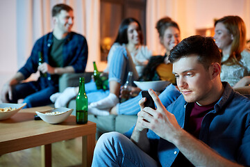 Image showing man with smartphone at home party