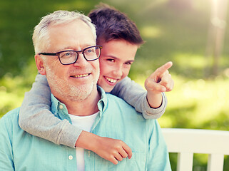 Image showing grandfather and boy pointing finger at summer park